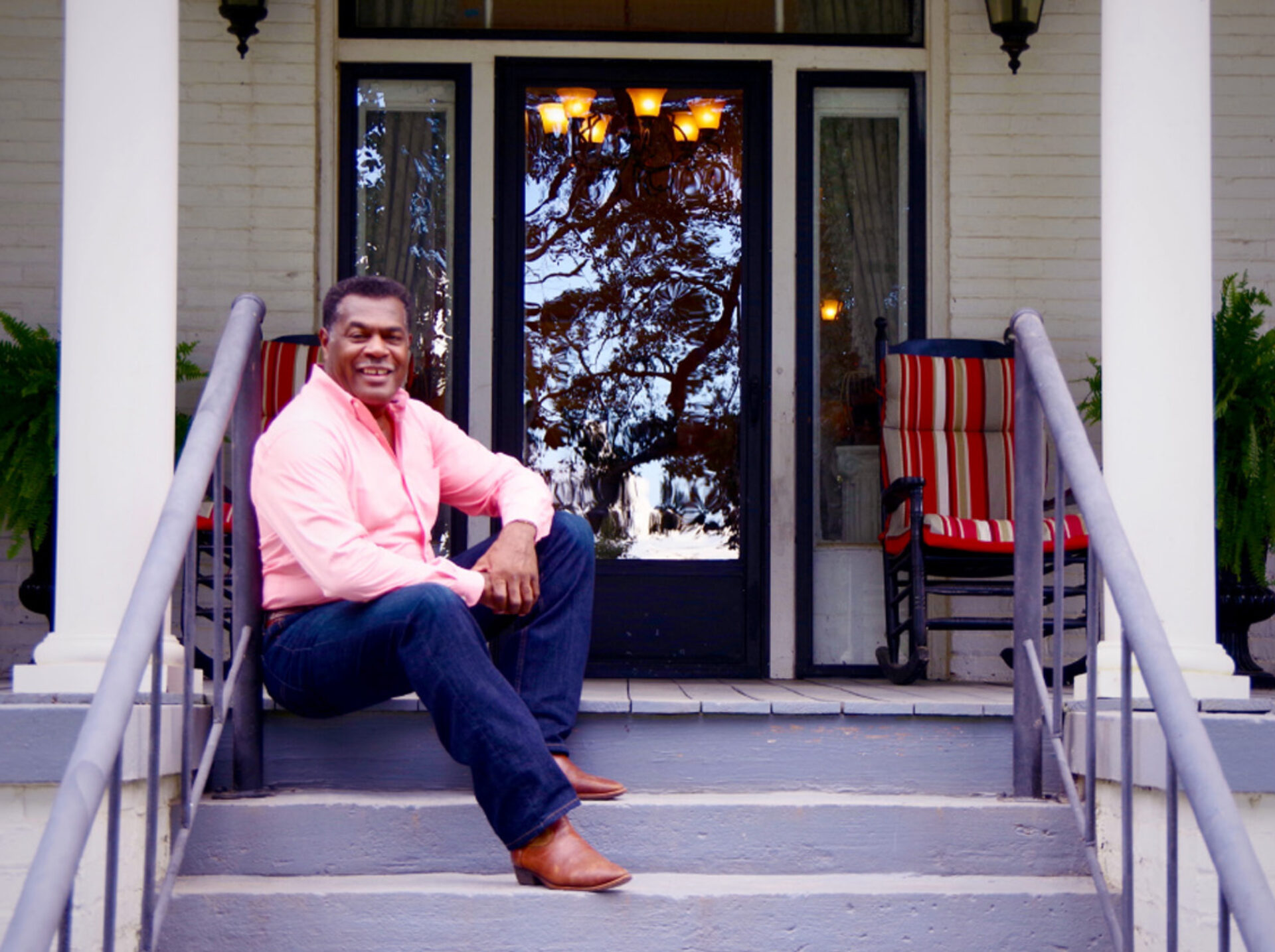 Charles Graham Sitting on Front Porch of "The Fountains" house